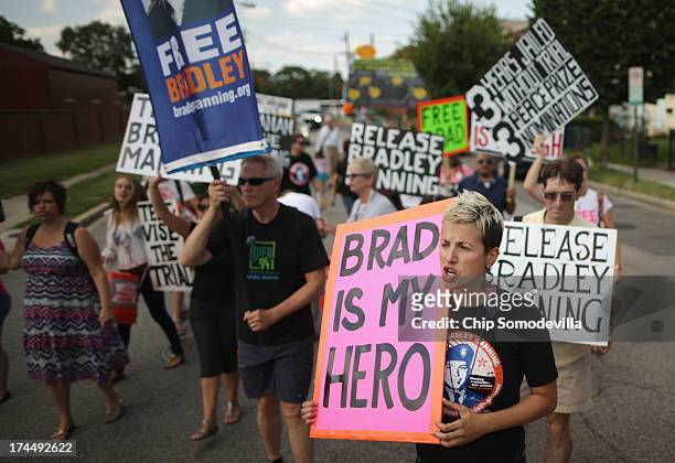 Supporters of U.S. Army Private First Class Bradley Manning protest his detention by marching around the perimeter and blocking the gates of Fort...
