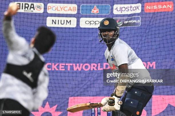 Sri Lanka's Angelo Mathews bats in the nets during a practice session on the eve of their 2023 ICC Men's Cricket World Cup one-day international...