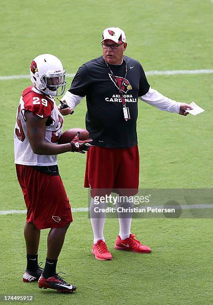 Head coach Bruce Arians of the Arizona Cardinals talks with runningback Alfonso Smith during the team training camp at University of Phoenix Stadium...