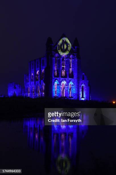English Heritage lights up the ruins of the iconic Whitby Abbey in North Yorkshire for Illuminated Abbey on October 19, 2023 in Whitby, England. The...