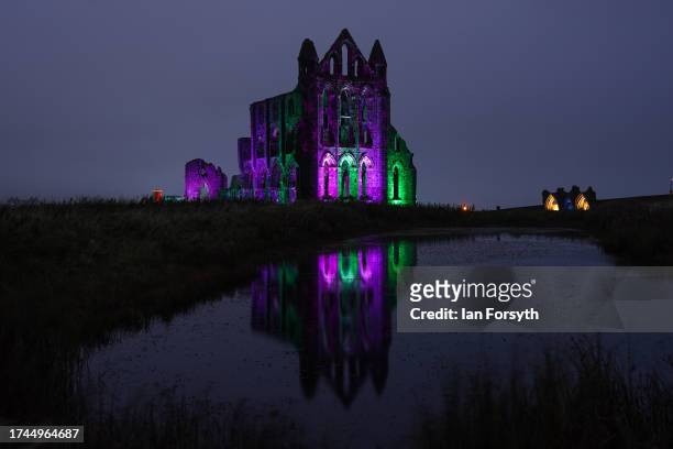 English Heritage lights up the ruins of the iconic Whitby Abbey in North Yorkshire for Illuminated Abbey on October 19, 2023 in Whitby, England. The...