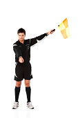 Football official signals a penalty on white
