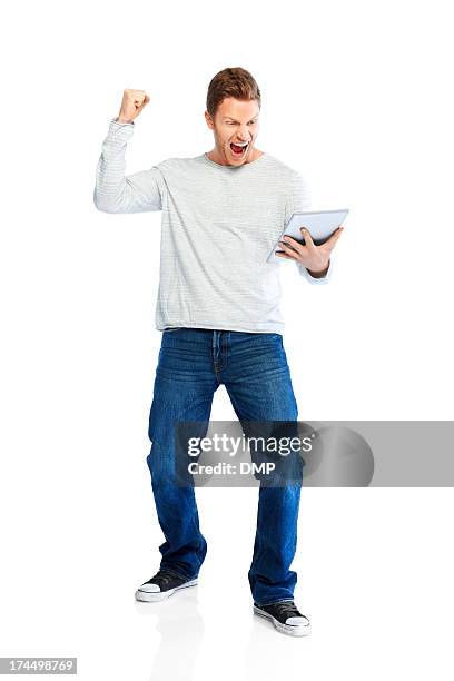 victory - successful young man raising fist using tablet pc - man ipad isolated stock pictures, royalty-free photos & images