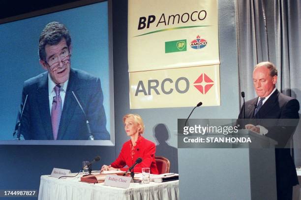 Amoco CEO Sir John Browne speaks at press conference in London while Atlantic Richfield Company chief financial officer Marie Knowles and BP Amoco...