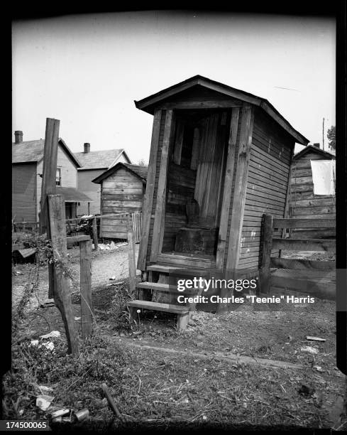 Leaning wood-framed outhouse in back yard next to alley, Pittsburgh, Pennsylvania, c. 1938