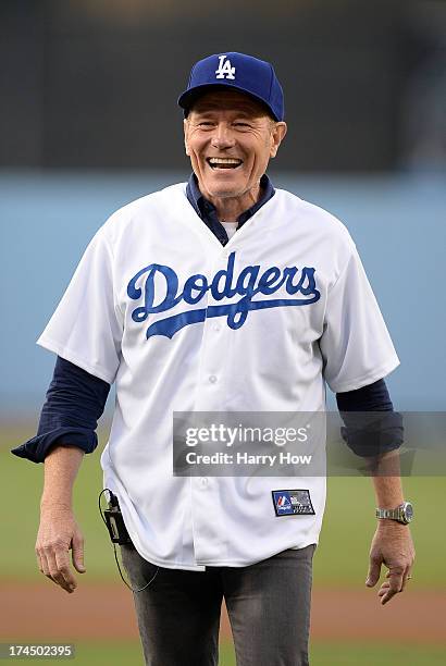 Actor Bryan Cranston reacts to his ceremonial first pitch before the game between the Cincinnati Reds and the Los Angeles Dodgers at Dodger Stadium...