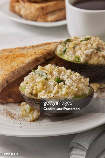 avocado egg salad boats - stuffed avocado stock pictures, royalty-free photos & images
