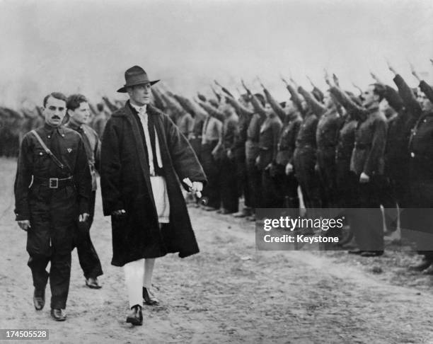 Romanian politician Corneliu Zelea Codreanu , wearing Romanian peasant dress, as he inspects members of the Iron Guard, the fascist movement of which...