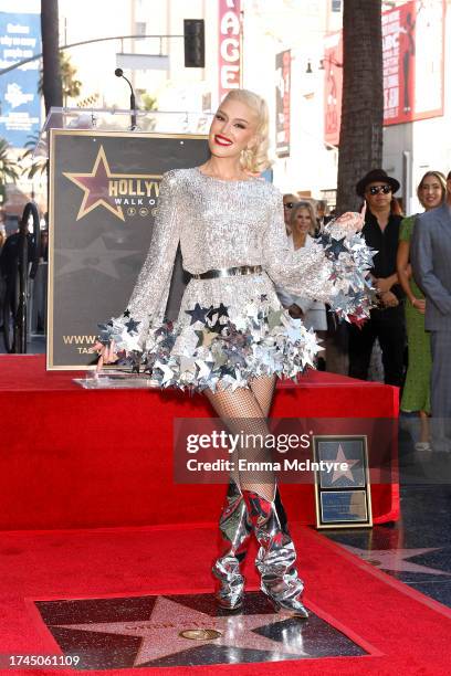 Gwen Stefani poses with her star during her Hollywood Walk of Fame Star Ceremony on October 19, 2023 in Hollywood, California.