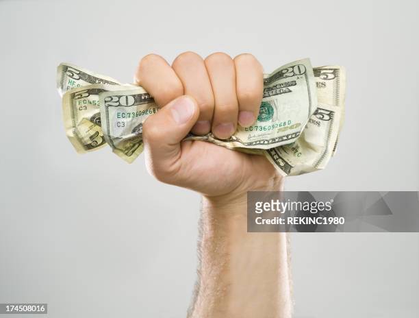 money in hand - gripping arm stock pictures, royalty-free photos & images
