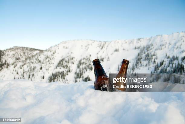 two cold beer in snow on top of a mountain - beer bottle cheers stock pictures, royalty-free photos & images