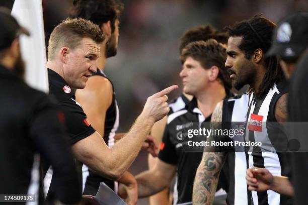 Coach Nathan Buckley of the Magpies speaks with Harry O'Brien of the Magpies during the round 18 AFL match between the Collingwood Magpies and the...