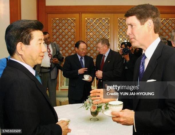 South Korean President Roh Moo-Hyun talks with US Senate Majority leader Bill Frist during a luncheon meeting with US senators at the presidential...