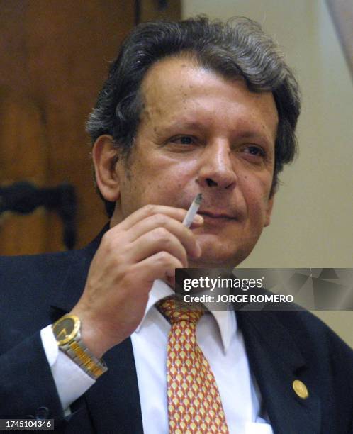 The president of Paraguay's Senate, Juan Carlos Galaverna, smokes a cigarette during the fifth session of the Senate impeachment trial of Paraguayan...
