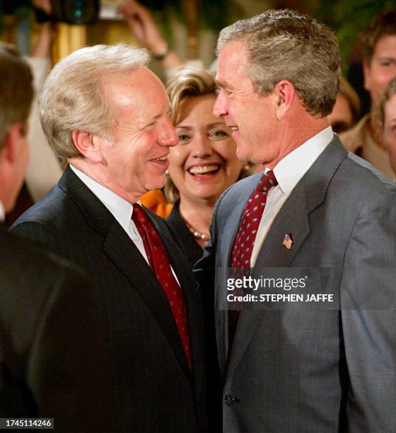 President George W. Bush speaks with US Senator and Democratic presidential hopeful Joe Lieberman and Hillary Rodham Clinton after an event in the...
