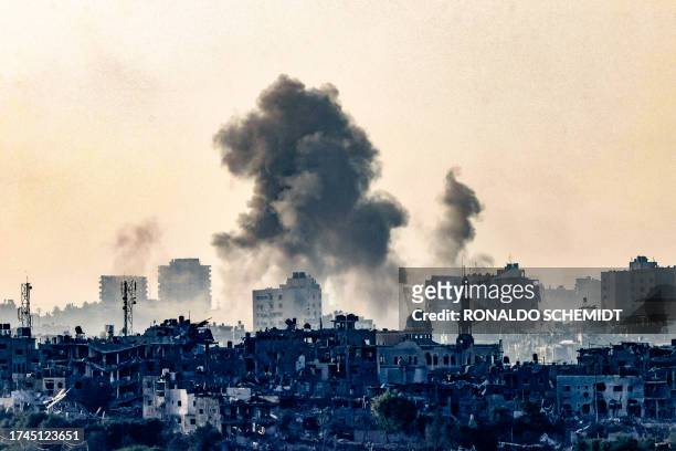 Picture taken from the southern Israeli city of Sderot on October 25 shows smoke ascending over the northern Gaza Strip following an Israeli strike,...