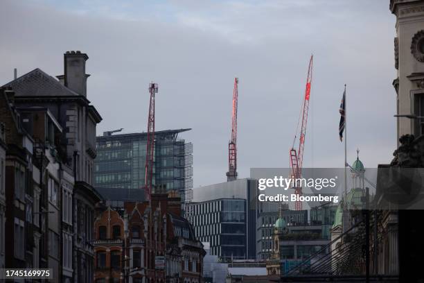 Construction cranes above commercial office buildings in London, UK, on Wednesday, Oct. 25, 2023. British workers coming into the office every day...