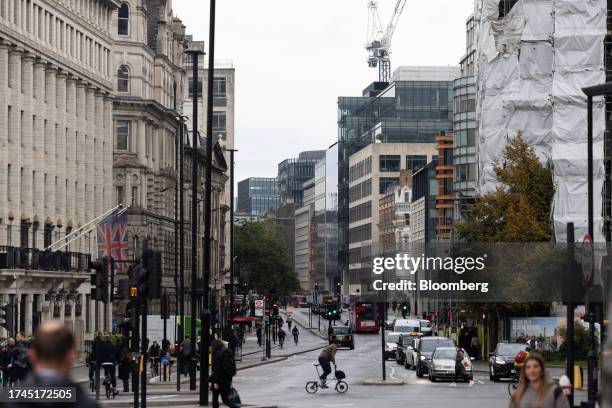 Cyclist rides a Brompton fold-up bicycle near Blackfriar's Bridge in London, UK, on Wednesday, Oct. 25, 2023. British workers coming into the office...