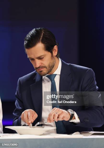 Jury member Prince Carl Philip of Sweden tastes dish during the Chef of the Year 2023 final competition at Annexet on October 19, 2023 in Stockholm,...