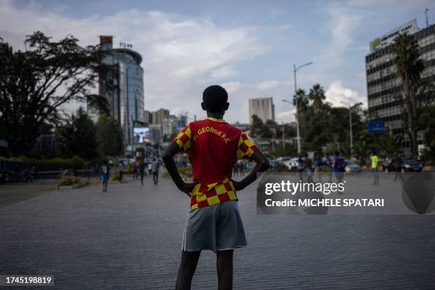 Kid covers the goalkeeper position as he plays table football outside the National Theatre in Addis Ababa on October 25, 2023.