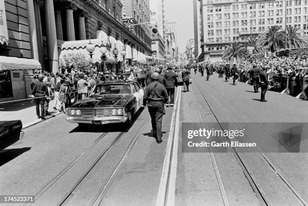 As police stand in the road, supporters and protestors press against barricades on both sides of Powell Street as they await for President Nixon's...