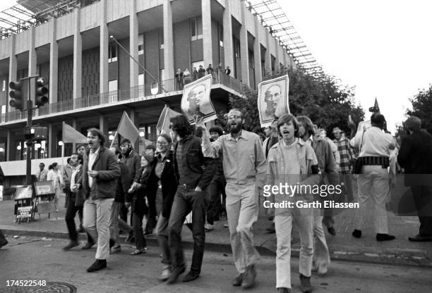 Anti-Vietnam War demonstrators carry posters of President of North Vietnam Ho Chi Minh as they march during a rally, Berkeley, California, September...