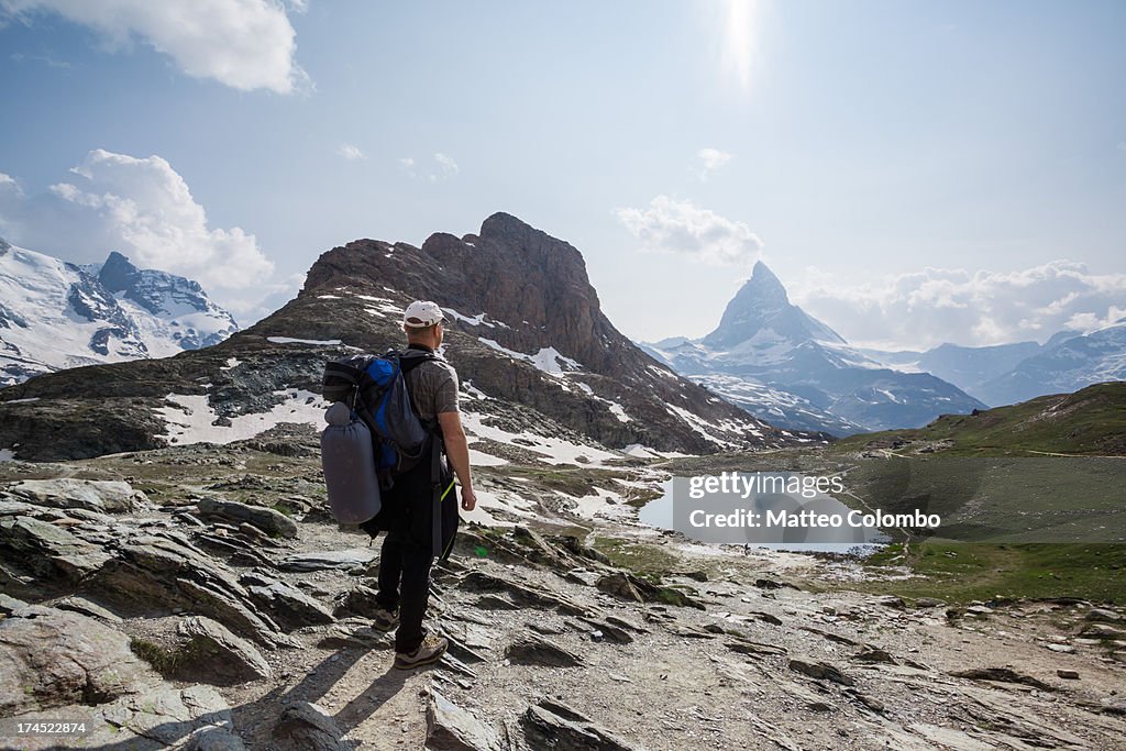 Hiker looking at Matterhorn mountain in summer