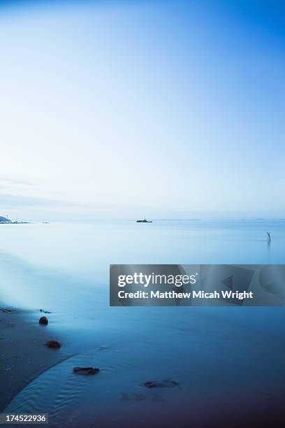 a statue in the water off the coast of livingston - livingston guatemala stock pictures, royalty-free photos & images