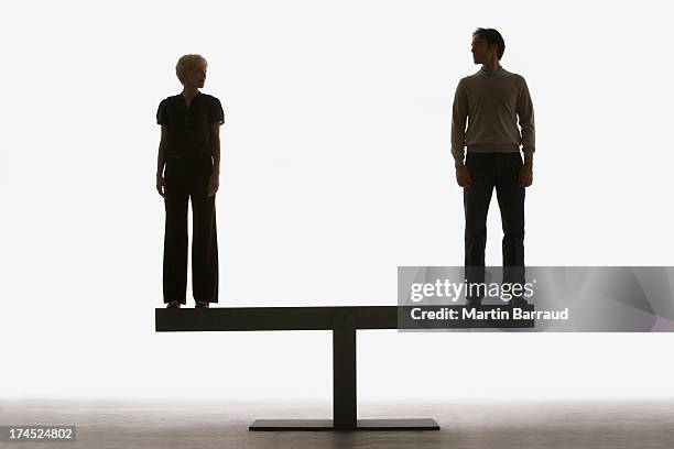 two people standing on top of a plank - gender identity stockfoto's en -beelden