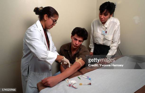 Young man is photographed October 30, 1986 getting tested for AIDS at a Renaissance Health Care Network Diagnostic and Treatment Center in New York...