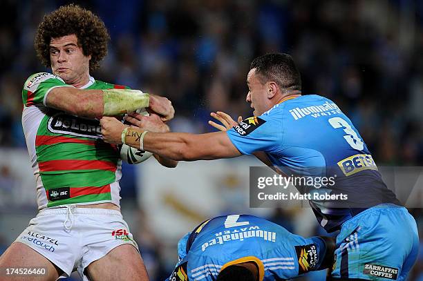 Matt King of the Rabbitohs is tackled during the round 20 NRL match between the Gold Coast Titans and the South Sydney Rabbitohs at Skilled Park on...