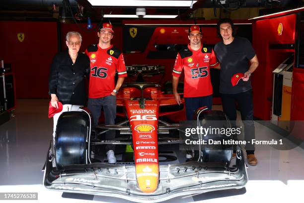 Charles Leclerc of Monaco and Ferrari and Carlos Sainz of Spain and Ferrari give Adam Driver and Michael Mann a tour of the Ferrari garage during...