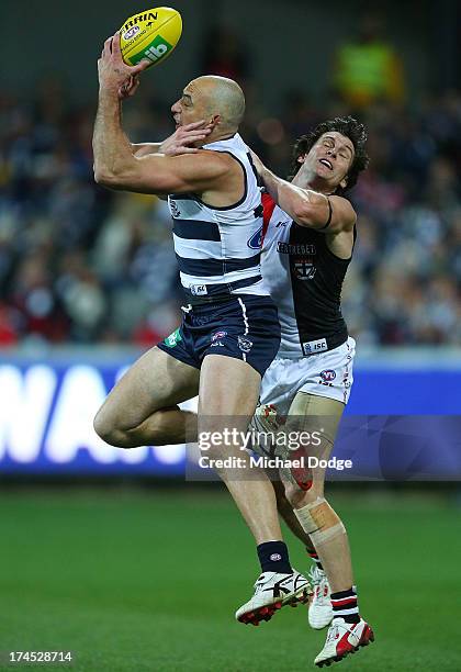 James Podsiadly of the Cats marks the ball against Tom Simpkin of the Saints during the round 18 AFL match between the Geelong Cats and the St Kilda...
