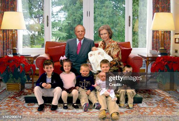 Picture released 22 December 2005 by the Spanish Royal House shows Spanish King Juan Carlos and Queen Sofia, holding their newborn grandchild Leonor,...