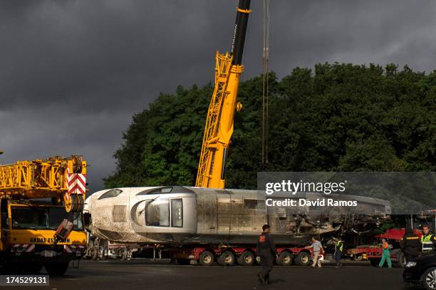 Crane extends above the train engine as its stored in a warehouse in Escravitude, 20 km from Santiago de Compostela after a train crash killed 78 on...