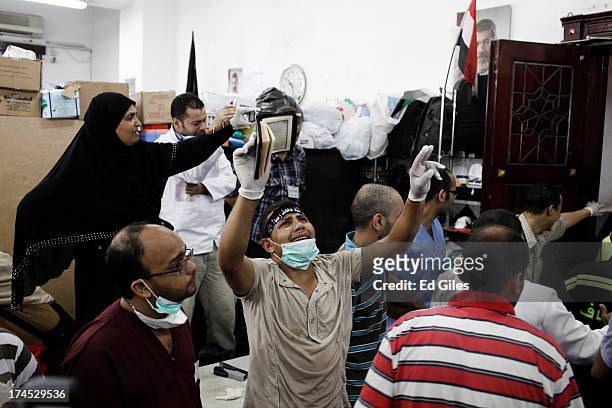 Supporter of deposed Egyptian President Mohammed Morsi yells inside a field hospital where bodies of supporters of Morsi are brought after reportedly...