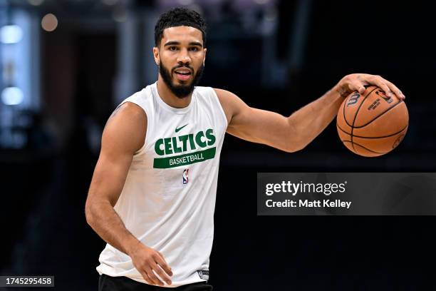 Jayson Tatum of the Boston Celtics warms up prior to the preseason game against the Charlotte Hornets at Spectrum Center on October 19, 2023 in...