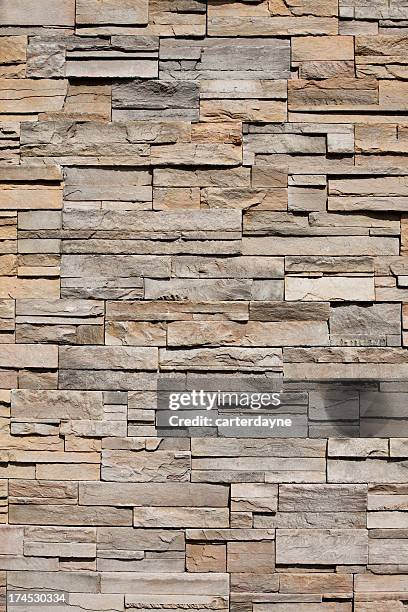 closeup of a sandstone brick side of building - stenen muur stockfoto's en -beelden