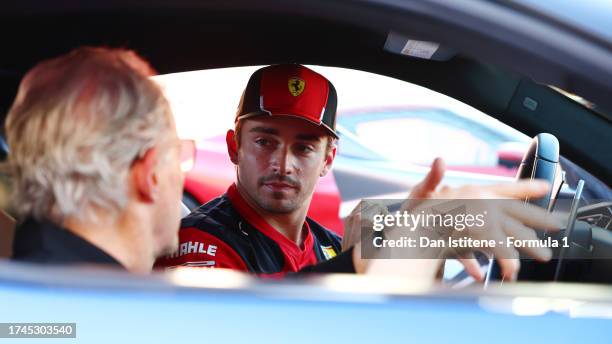 Charles Leclerc of Monaco and Ferrari prepares to give Michael Mann a Hot Lap during previews ahead of the F1 Grand Prix of United States at Circuit...