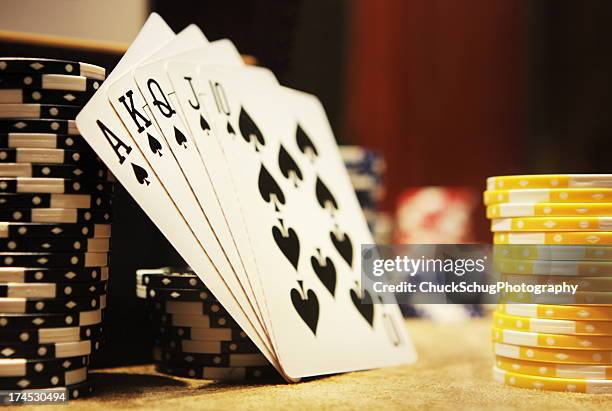 gambling poker hand royal flush spades - vegas gambling stock pictures, royalty-free photos & images