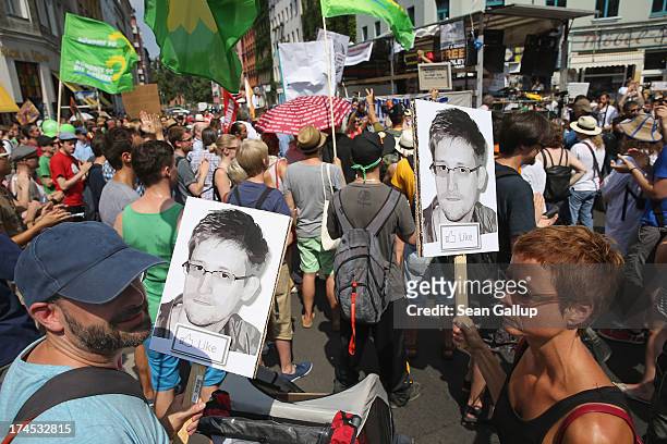 Participants demonstrate in support of former NSA employee Edward Snowden at a protest march against the electonic surveillance tactics of the NSA on...