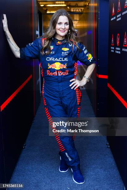 Drew Barrymore poses for a photo in the Red Bull Racing garage during previews ahead of the F1 Grand Prix of United States at Circuit of The Americas...