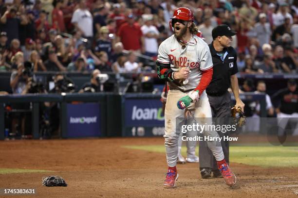 Bryce Harper of the Philadelphia Phillies celebrates after scoring a run off of a wild pitch thrown by Ryan Thompson of the Arizona Diamondbacks...