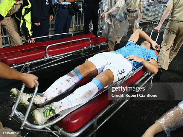 Matija Nastasic of Mancester City is taken from the ground with an injury during the Barclays Asia Trophy Final match between Manchester City and...