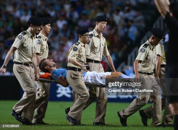 Matija Nastasic of Mancester City is taken from the ground with an injury during the Barclays Asia Trophy Final match between Manchester City and...