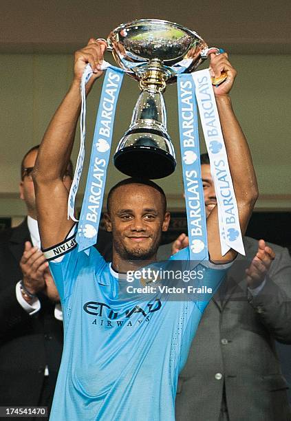 Vincent Kompany of Manchester City holds the trophy aloft after winning the Barclays Asia Trophy Final match against the Sunderland at Hong Kong...