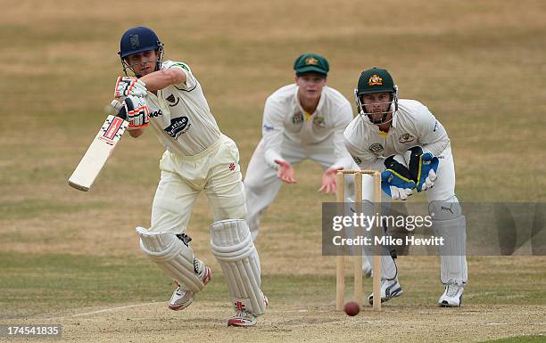 James Taylor of Sussex drives at a ball from Nathan Lyon of Australia to the boundary as wicketkeeper Matthew Wade and slip Steve Smith look on...