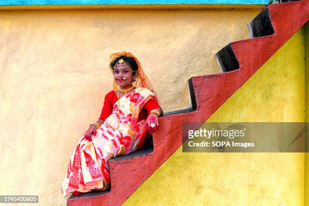 Little girl poses for a photo before the Kumari Puja Ritual. Kumari Puja is an Indian Hindu tradition mainly celebrated during the Durga Puja...