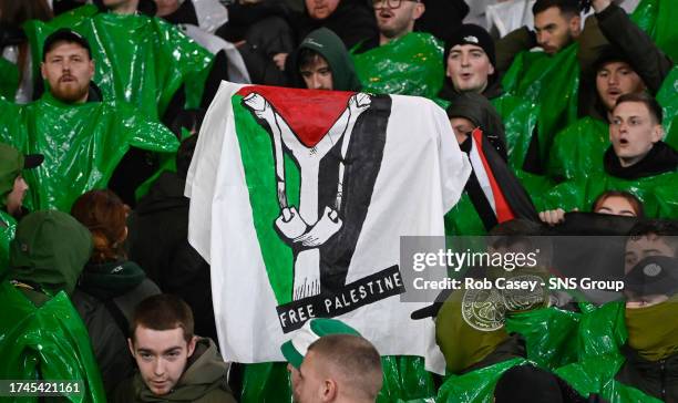 Celtic fans hold up Palestine flags during a UEFA Champions League match between Celtic and Atletico de Madrid at Celtic Park, on October 25 in...