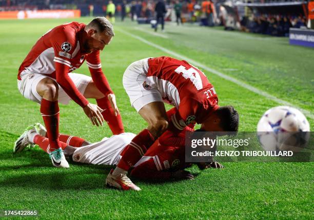 Antwerp's Nigerian midfielder Alhassan Yusuf celebrates with teammates Antwerp's Dutch midfielder Jurgen Ekkelenkamp and Antwerp's Dutch forward...